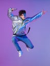 Cool guy dancing contemporary dance in studio. Neon light background. Acrobatic bboy dancer. Break dance lessons. Royalty Free Stock Photo