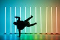 Guy dancing contemporary dance in studio. Neon light tube background. Acrobatic bboy dancer. Break dance lessons. Royalty Free Stock Photo