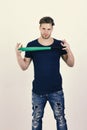 Guy in dark blue tshirt holds bright green bat in hands. Sports and baseball training concept. Player with confident Royalty Free Stock Photo