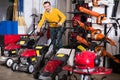 Guy demonstrates professional grass cutters Royalty Free Stock Photo