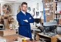 Guy displaying his workplace and tools at workshop Royalty Free Stock Photo