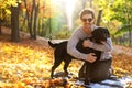 Guy with dog labrodor in autumn park at sunset Royalty Free Stock Photo