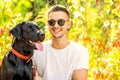 Guy with a dog walks in a park in autumn Royalty Free Stock Photo