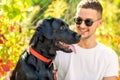 Guy with a dog walks in a park in autumn Royalty Free Stock Photo