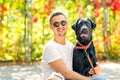 Guy with a dog walks in a park in autumn Royalty Free Stock Photo