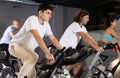 Guy doing cardio training on stationary bike in gym Royalty Free Stock Photo