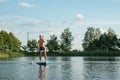 Guy doing paddle boarding on lake, lucky man on SUP Board Royalty Free Stock Photo