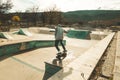 Guy doing skateboarding tricks at the skatepark Royalty Free Stock Photo