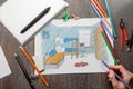 Guy drawing a boys` room sketch with colored pencils