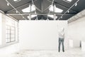 Guy drawing in warehouse interior Royalty Free Stock Photo