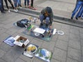 The guy draws pictures in a few minutes using paint from a can