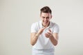 Guy dressed in a white t-shirt and jeans nickers on a white background in the studio