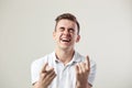 Guy dressed in a white t-shirt and jeans nickers on a white background in the studio