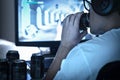 Guy drinking soda and playing video game or watching online live stream. Too much energy drink. Many empty cans of cola. Royalty Free Stock Photo