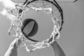 guy dunking basketball ball through net ring with hands, targeting Royalty Free Stock Photo