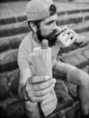 Guy eating hot dog. Man bearded bite tasty sausage and drink paper cup. Street food so good. Urban lifestyle nutrition