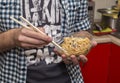 Man eats fried rice with chopsticks for sushi