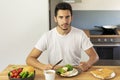 The guy eats toast and scrambled eggs with bacon Royalty Free Stock Photo