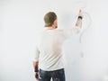 Guy erasing a question mark on a white wall Royalty Free Stock Photo