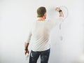 Guy erasing a question mark on a white wall Royalty Free Stock Photo