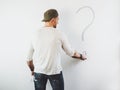 Guy erasing a question mark on a white wall Royalty Free Stock Photo