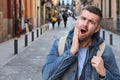 Guy experimenting intense toothache outdoors Royalty Free Stock Photo