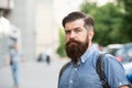 Guy exploring city. Comfortable tourism. Summer vacation. Hipster wearing backpack urban street background. Bearded man Royalty Free Stock Photo