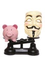 Guy fawkes mask with piggy bank Royalty Free Stock Photo