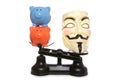 Guy fawkes mask with two piggy banks Royalty Free Stock Photo