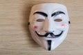 Guy Fawkes Mask on a Wooden Background Royalty Free Stock Photo