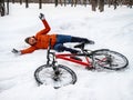 A guy fell off his bike in a winter park Royalty Free Stock Photo