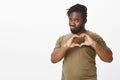 Guy always find way to women hearts. Good-looking flirty african-american in military t-shirt, showing heart gesture