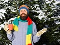 Guy with firtrees covered with snow on background. Royalty Free Stock Photo