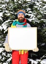 Guy with firtrees covered with snow on background. Royalty Free Stock Photo