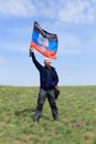 Guy with the flag DPR in the tulip field, Rostov region, Russia