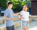 Guy flirts with girl on city street Royalty Free Stock Photo