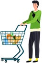 Guy with food cart makes purchases, buys goods in supermarket. Man with grocery trolley shopping