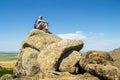 Guy gazing in the distance, while standing on top of a strange rock formation, during an Autumn hike Royalty Free Stock Photo