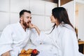 The guy and the girl bathrobe, girl feeds the guy fruit