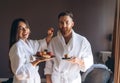 The guy and the girl bathrobe, girl feeds the guy fruit