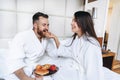 The guy and the girl bathrobe, girl feeds the guy fruit