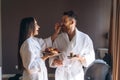 The guy and the girl bathrobe, girl feeds the guy fruit