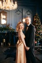 A guy with a girl is celebrating Christmas. A loving couple enjoy each other on New Year`s Eve. Royalty Free Stock Photo