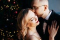 A guy with a girl is celebrating Christmas. A loving couple enjoy each other on New Year`s Eve. Royalty Free Stock Photo