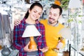 Guy and a girl choose bedside lamps