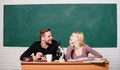 Guy and girl at desk with microscope. Studying in college or university. Biology lesson. Students studying university