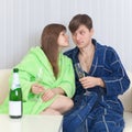 Guy and girl drink champagne wine on a sofa Royalty Free Stock Photo