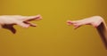 The guy and the girl give five, hit the cams on a yellow background isolated in the studio. Success, lucky team