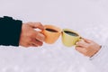 Two cups of coffee in the hands of happy couple. Winter theme Royalty Free Stock Photo