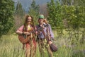 Guy and a girl in hippie style with a guitar in a forest clearing Royalty Free Stock Photo